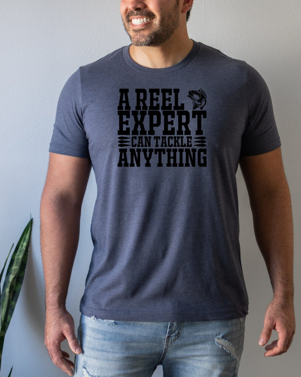 A reel expert can tackle anything black lettering navy t-shirt