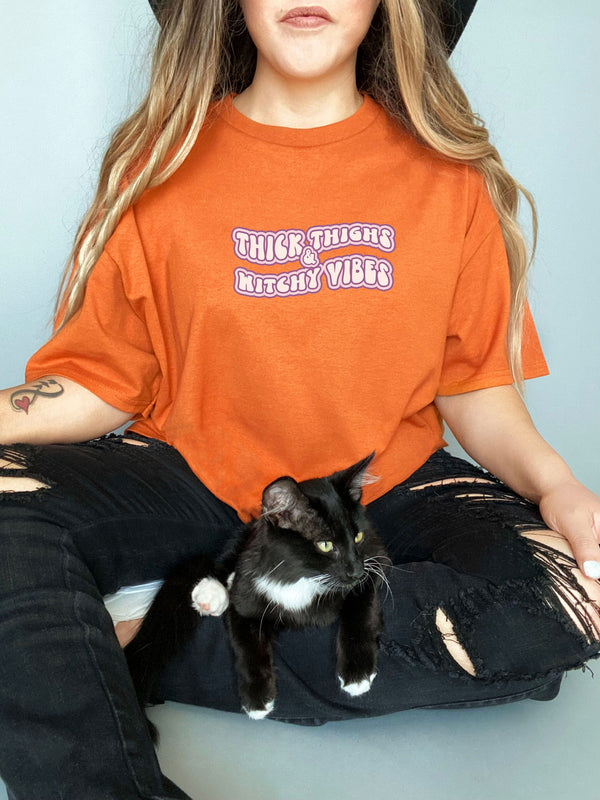 Thick Thighs and Witchy Vibes on Gildan Orange T-Shirt