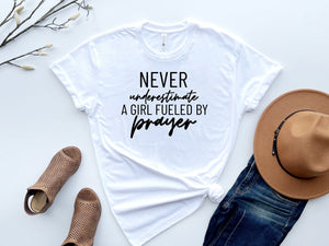 Never Underestimate a girl fueled by prayer essential t-shirt